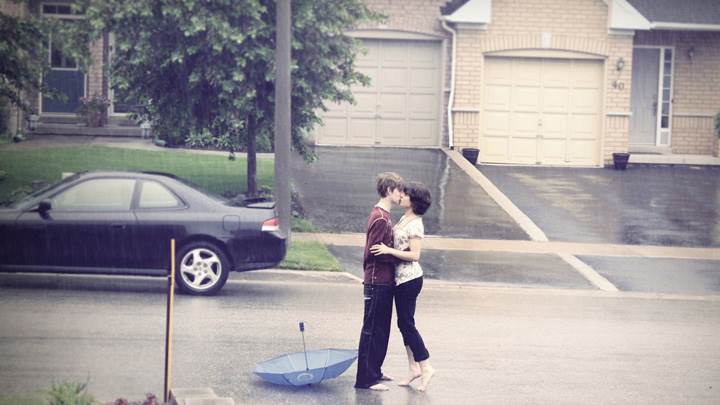 Couple Kissing on Road In Rain